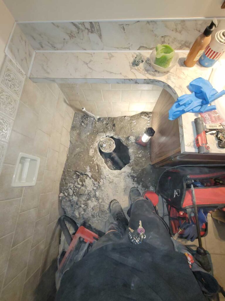 Plumber working on repairing a drain