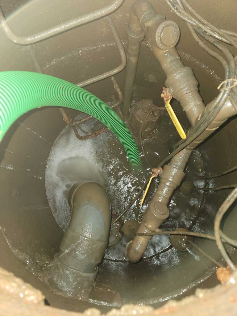 Plumber using a drain snake to unclog the drain