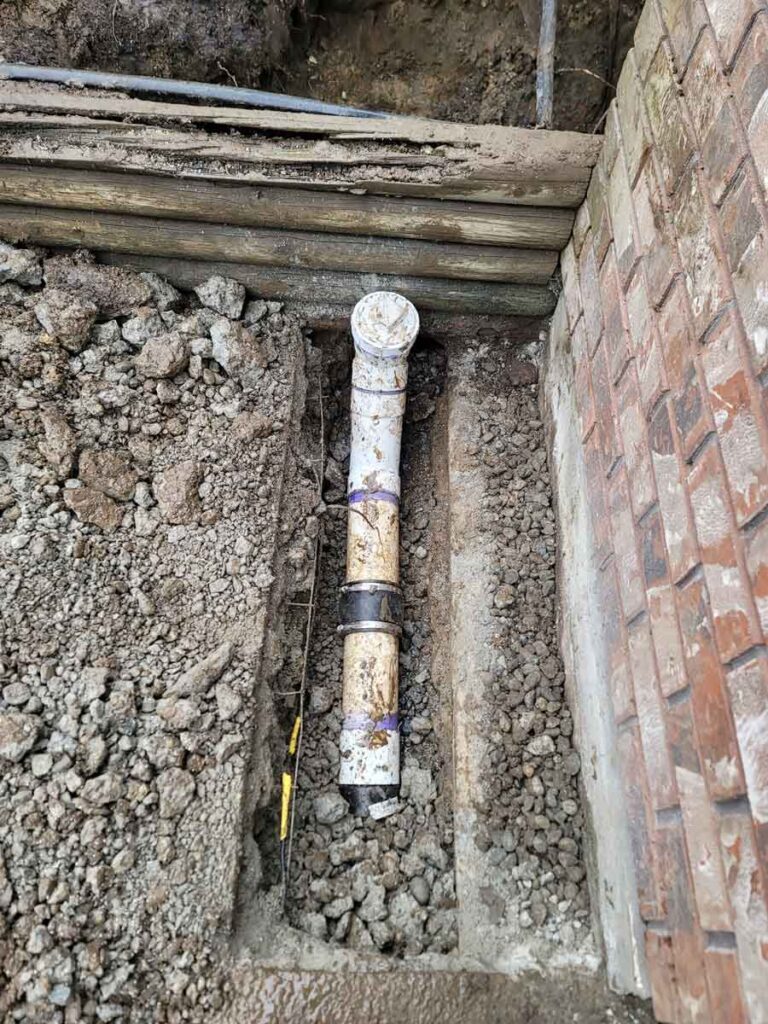 Damaged and exposed underground pipe