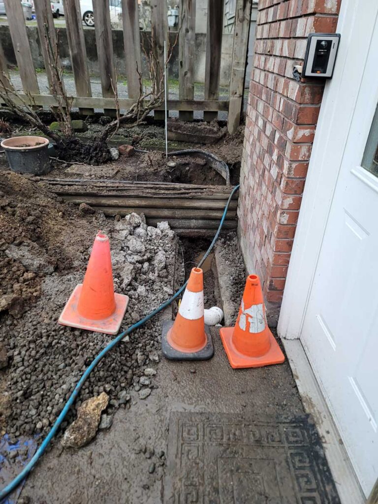 Orange safety cones indicating ongoing plumbing work