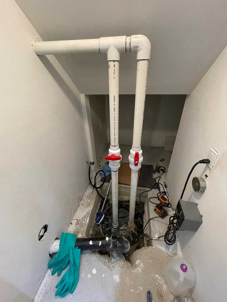 Plumbing pipes and tools in a basement