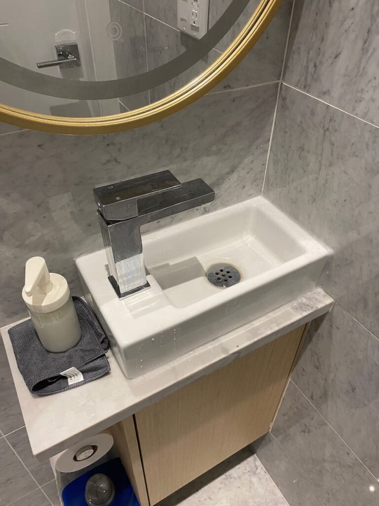 Newly installed bathroom vanity with modern sink and faucet