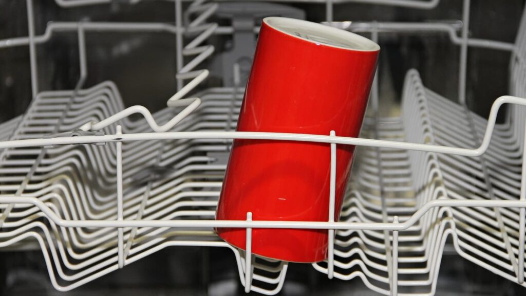 Dishwasher with red cup inside